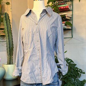 Office siren/ boyhood button up with a tapered waist.